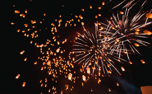 Low angle view of firework display at night