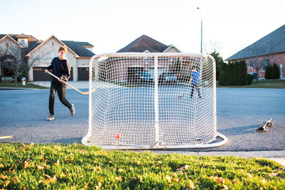 Man standing on soccer field against sky