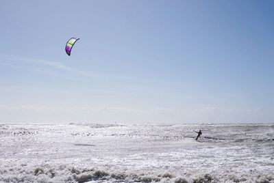 Man kite surfing on sea