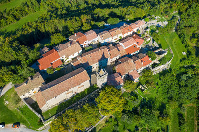 High angle view of houses and trees in city