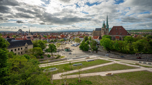 High angle view of road by buildings against sky