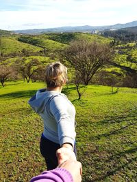 Rear view of woman standing on field