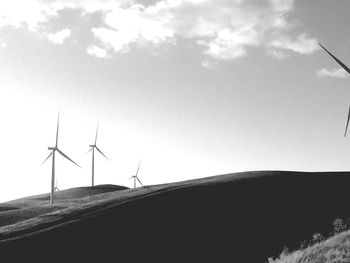 Low angle view of windmill against sky