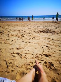 People at beach against sky