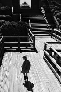 High angle view of woman walking on staircase
