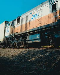 Train on railroad tracks against clear sky