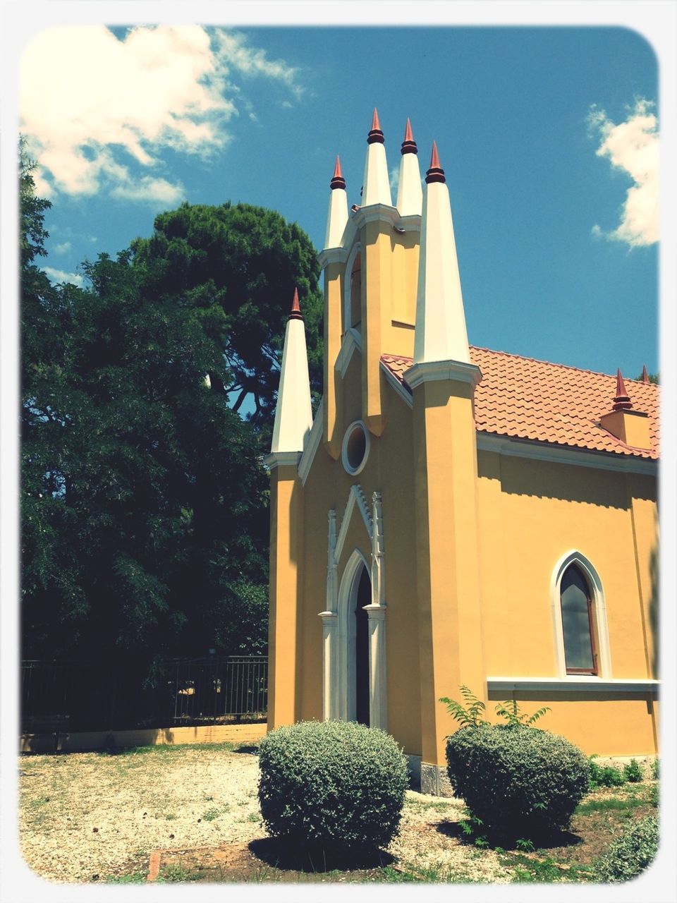 building exterior, architecture, built structure, religion, place of worship, sky, church, low angle view, spirituality, tree, transfer print, house, cross, cloud - sky, auto post production filter, growth, day, roof