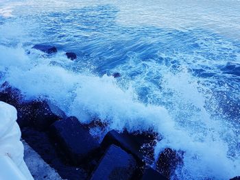 High angle view of waves splashing in sea