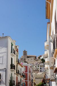 Low angle view of buildings against blue sky