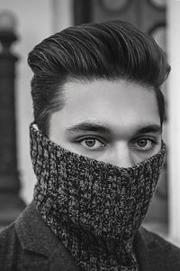 Close-up portrait of young man wearing turtleneck while standing outdoors