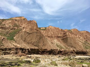 Rock formations on landscape against sky