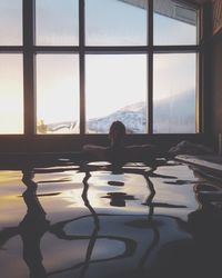 Woman looking through window