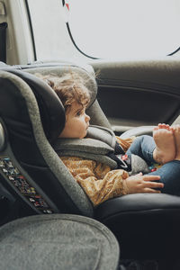 Low section of woman sitting in car