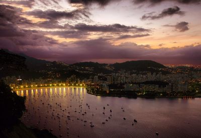 High angle view of sea and city from sugarloaf mountain at sunset