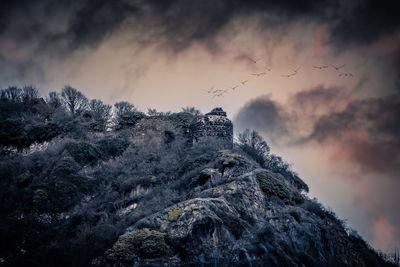 Low angle view of mountain against sky at sunset