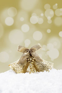 Close-up of christmas decorations on fake snow against illuminated background