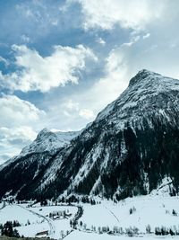 Scenic view of snow covered mountains against sky