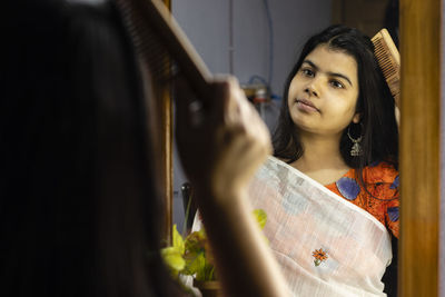 Portrait of young woman looking at camera