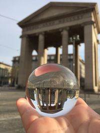 Cropped image of hand holding crystal ball