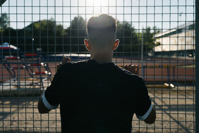 Rear view of man playing soccer