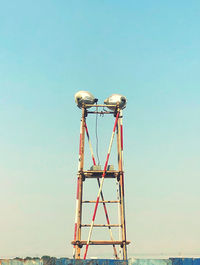 Low angle view of ferris wheel against clear sky