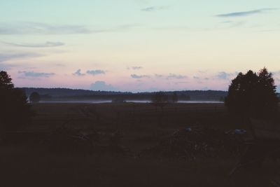 Scenic view of field against sky during sunset