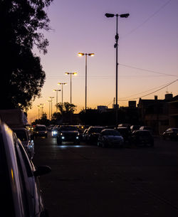 Traffic on road at sunset