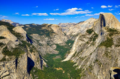 Scenic view of mountains against blue sky