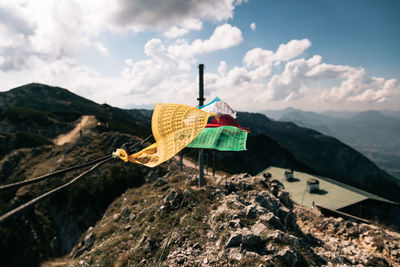 Close-up of umbrella hanging on mountain against sky