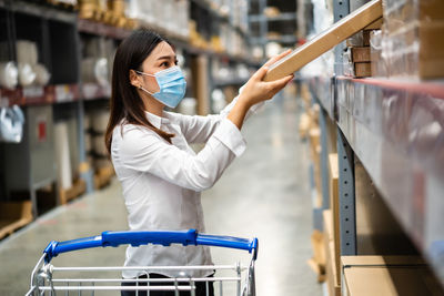 Woman holding umbrella standing in store