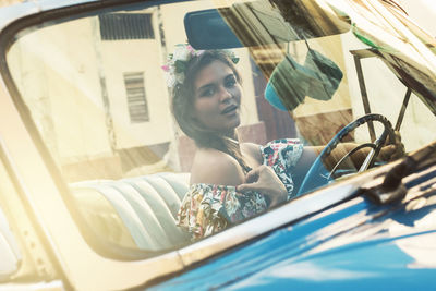 Portrait of young woman in car