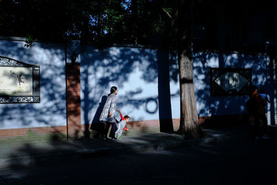 Man walking on footpath in city