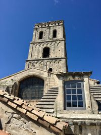 Low angle view of historic building against clear blue sky