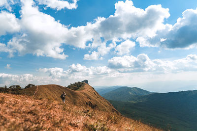 Full length of man standing on mountain against sky