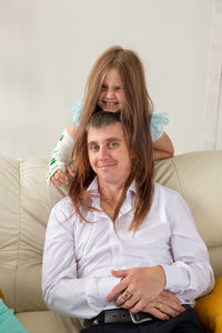 Portrait of smiling woman sitting at home