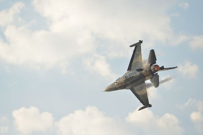 Low angle view of airplane flying against sky