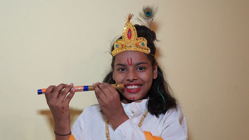 Happy janmashtami little indian boy posing as shri krishna or kanha or kanhaiya with flute.