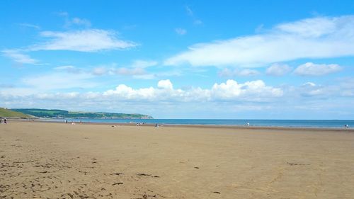 Scenic view of beach against blue sky