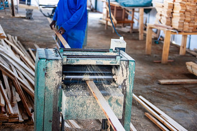 Midsection of man working in workshop