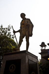 Low angle view of man statue against clear sky