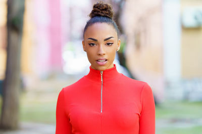 Portrait of young woman standing outdoors