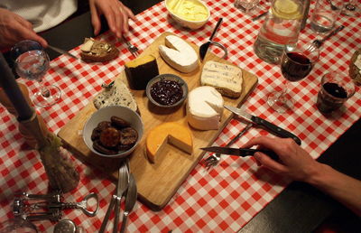High angle view of people preparing food on cutting board