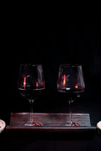 Close-up of wine glass on table against black background
