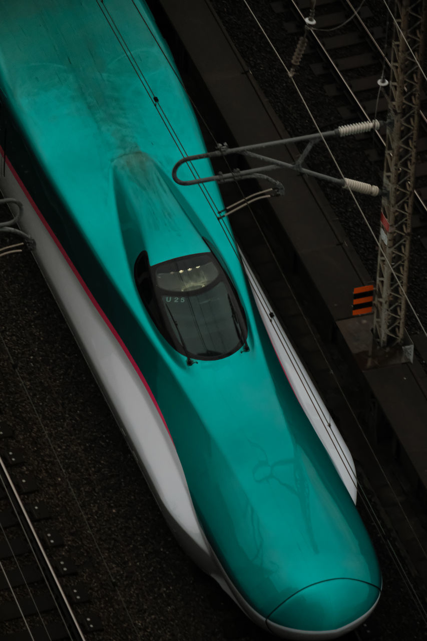 HIGH ANGLE VIEW OF TRAIN BY RAILROAD STATION