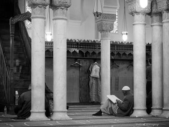 People sitting on old building