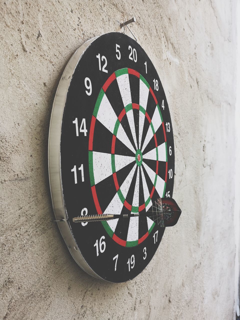 circle, wall - building feature, geometric shape, shape, number, close-up, no people, accuracy, sport, indoors, day, sports target, directly above, round, mounted, pattern, still life, relaxation, wall, high angle view, wheel, concrete