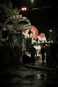 People on illuminated street at night