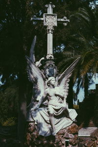 Statue against trees