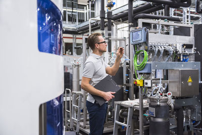 Man looking at screen in factory shop floor