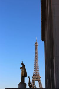 Low angle view of tower against blue sky